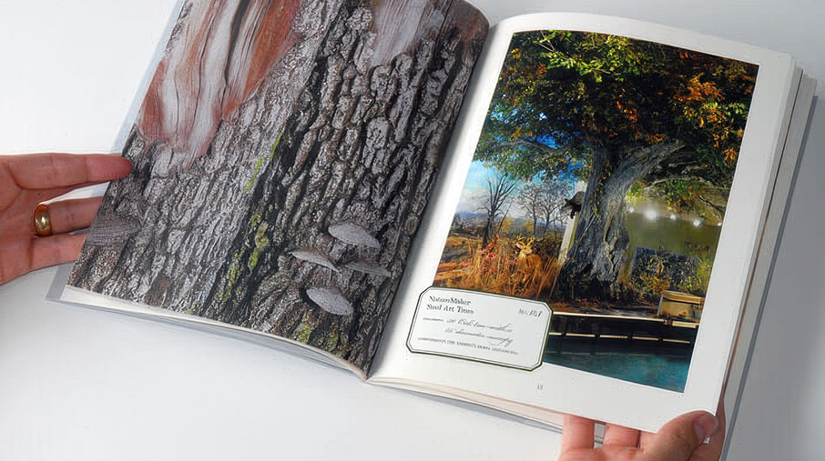 Open NatureMaker brochure held by a person, displaying a detailed close-up of textured tree bark with lichen and shelf fungus on the left page. The right page shows a vibrant, lifelike steel art tree installation with a wide canopy over a water feature, surrounded by naturalistic landscaping and warm lighting. A label on the image reads “NatureMaker – Soul of the Trees.”