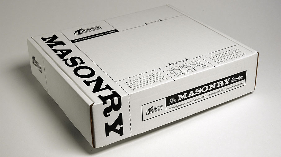 Closed white packaging box labeled 'The Masonry Binder' from Thompson Building Materials. The box features bold black typography reading 'MASONRY' along the side and includes simple line illustrations of different brick and stone patterns. Branding details, including the company’s logo and contact information, are printed on the front.