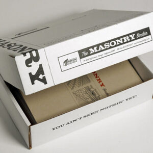 Partially opened white shipping box labeled 'The Masonry Binder' from Thompson Building Materials. Inside, a kraft-colored binder with architectural illustrations is visible. The inside flap of the box features bold text reading 'You Ain’t Seen Nothin’ Yet!' The packaging conveys a rugged and confident brand identity.