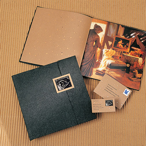 Printed brand collateral for Blackhorse, displayed on a textured tan surface. The set includes a large square black folder with a small label featuring the company logo, an open booklet showing interior photography of an artist’s studio with statues and framed paintings, and two business cards featuring coordinating earthy tones and minimalist design.