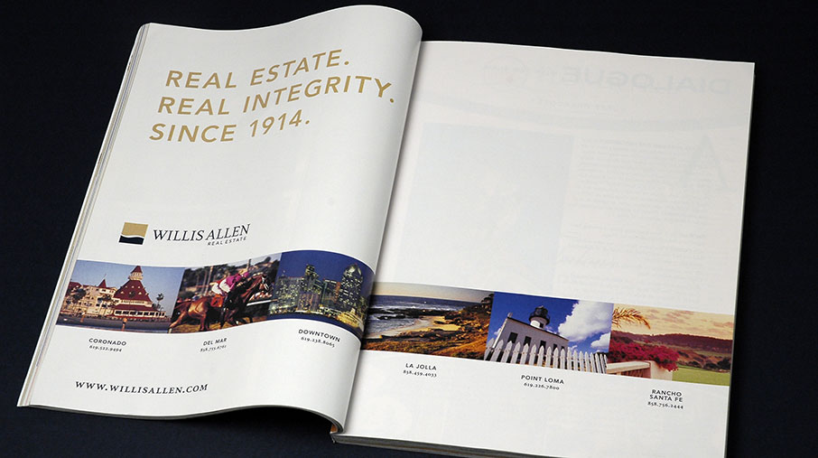 A full-page magazine advertisement for Willis Allen Real Estate. The left page features the tagline “REAL ESTATE. REAL INTEGRITY. SINCE 1914.” in gold uppercase letters, along with the Willis Allen logo and website URL (www.willisallen.com). Below is a horizontal strip of photos representing six office locations: Coronado, Del Mar, Downtown, La Jolla, Point Loma, and Rancho Santa Fe, each labeled with contact numbers. The right page is mostly blank, allowing the left page's message and visuals to stand out prominently.